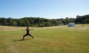 Woman doing warrior pose during outdoor yoga