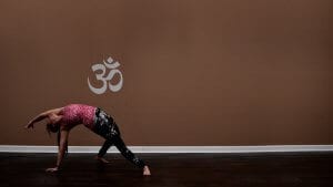 Woman doing revolving beam yoga pose