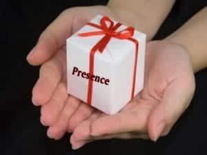 Two hands holding a gift which says "Presence"